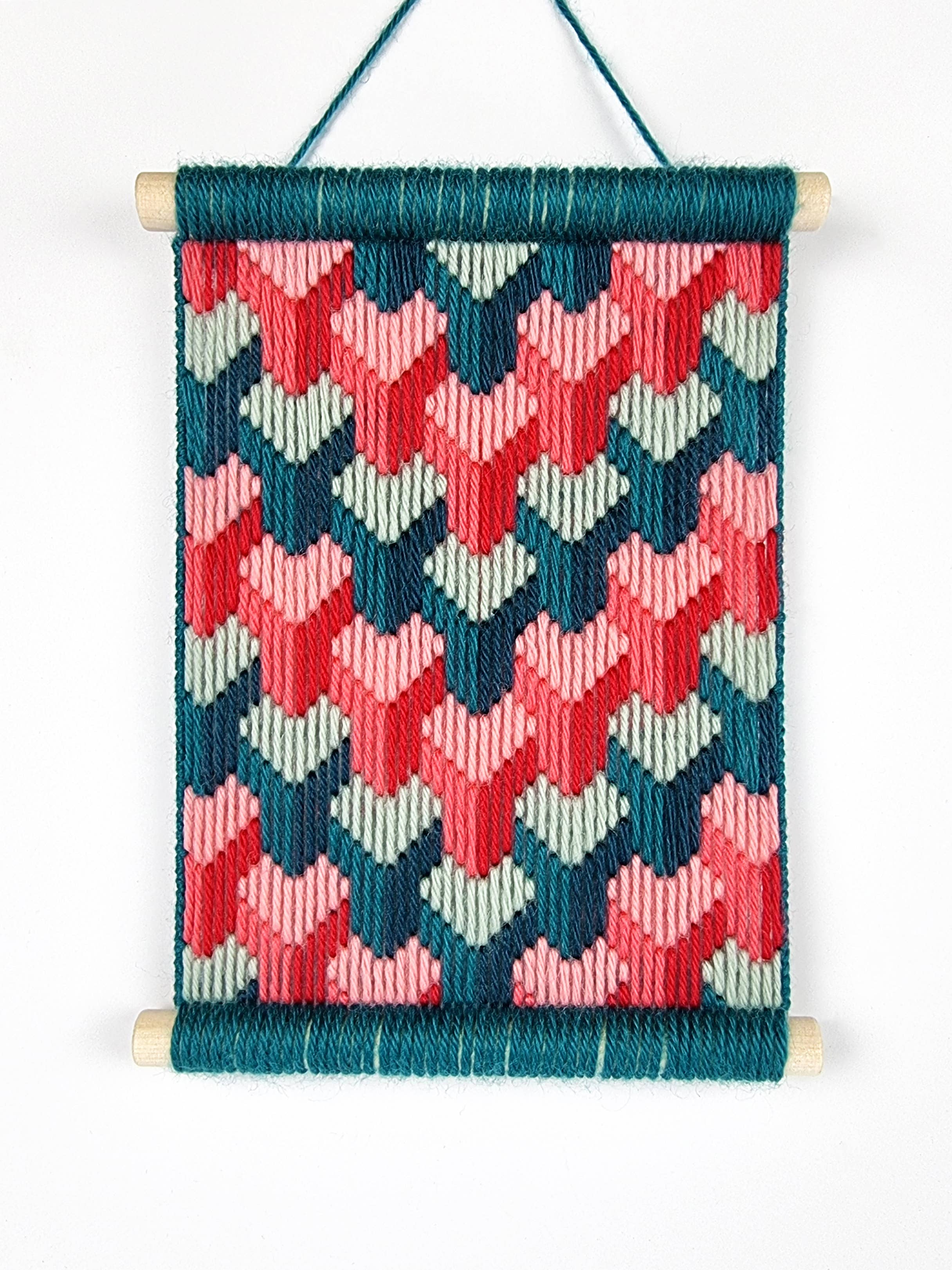 Woven wall hanging with geometric pattern on a white background