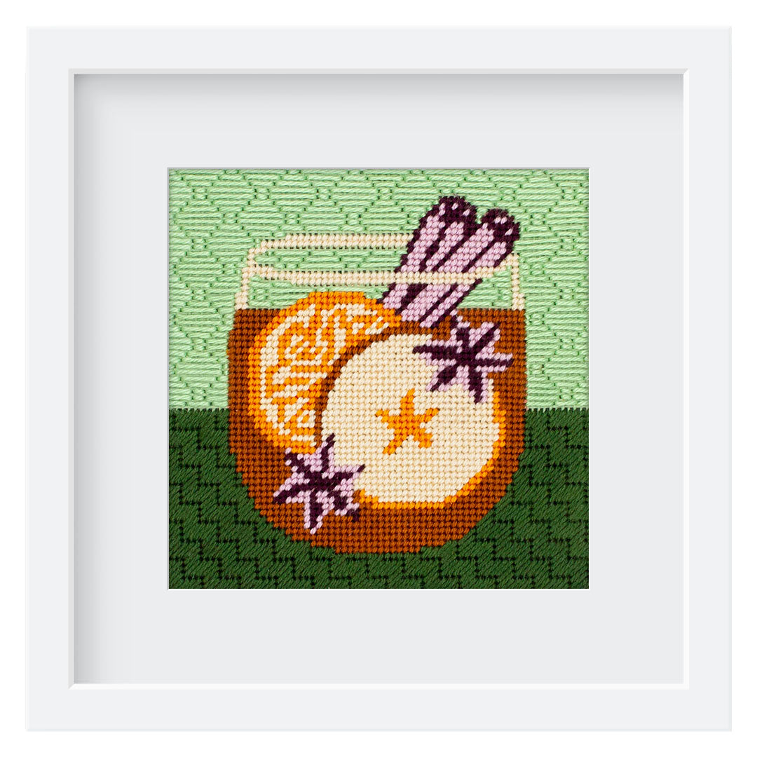 The Autumn Cider kit stitched and in a white frame.