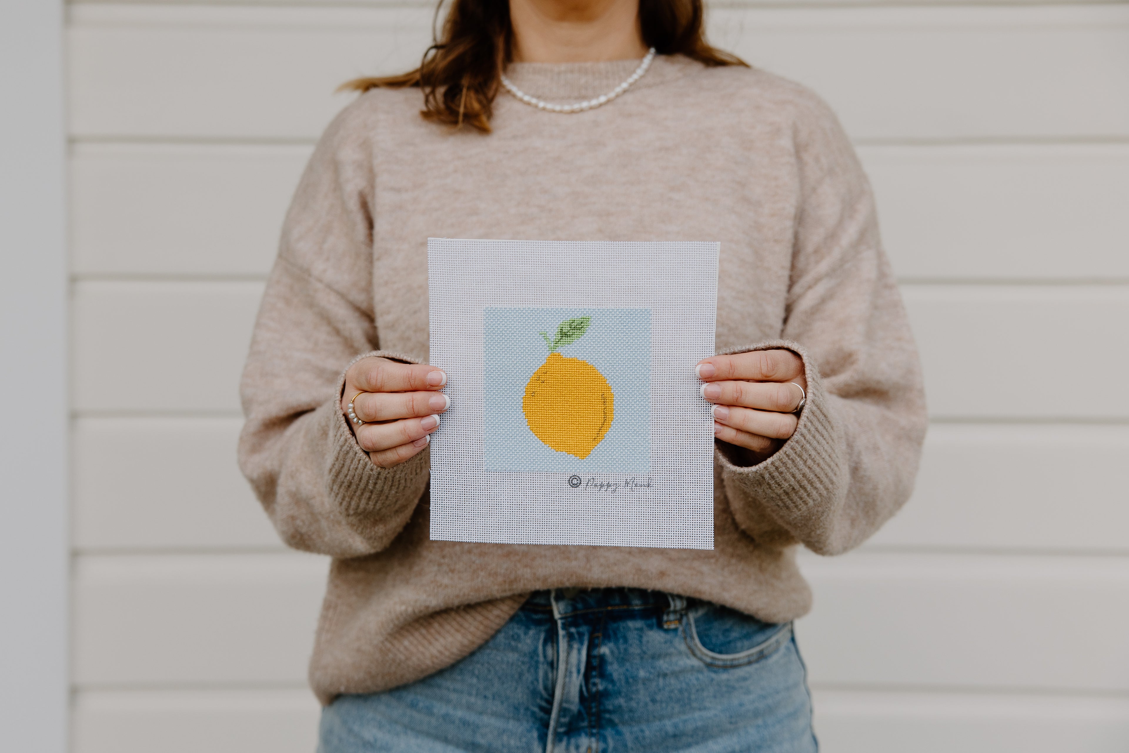woman holding lemon needlepoint design