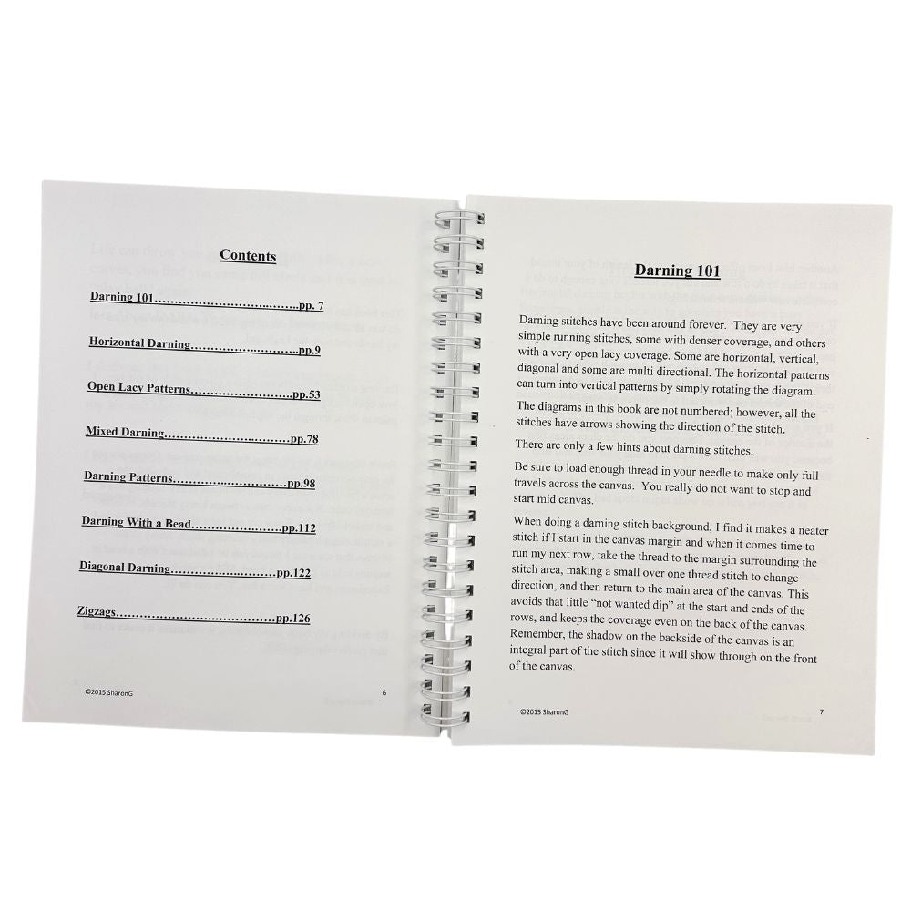 Open book showing pages with text and a table of contents on a white background