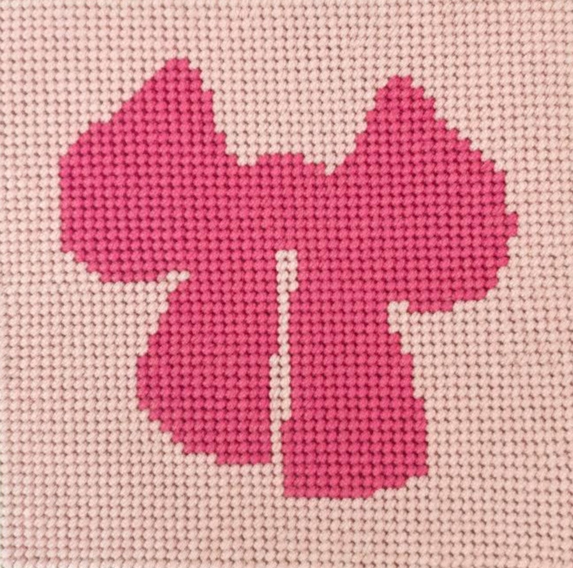 Pink bow design on a beige textured background