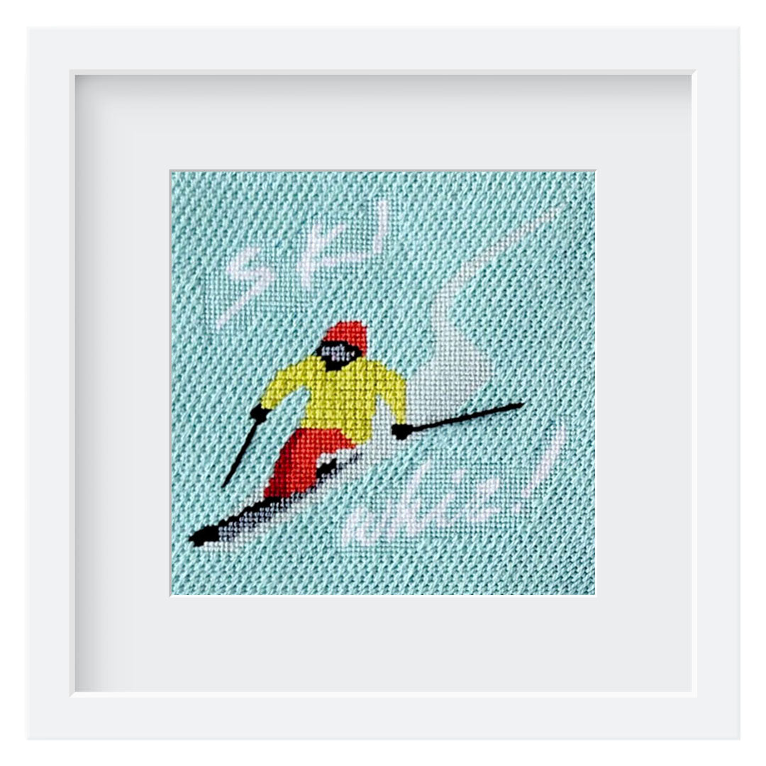 Ski Whiz needlepoint design featuring a skier in a white frame