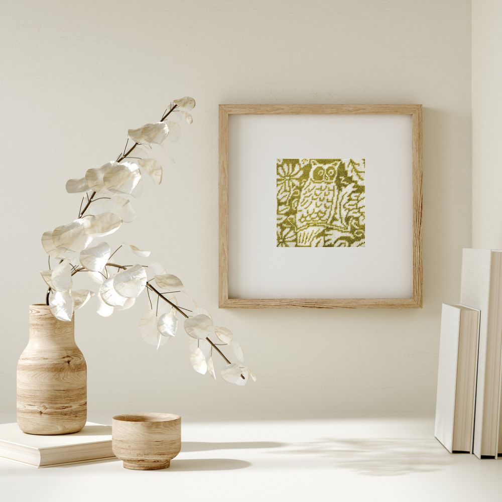 Needlepoint owl design shown framed on a wall