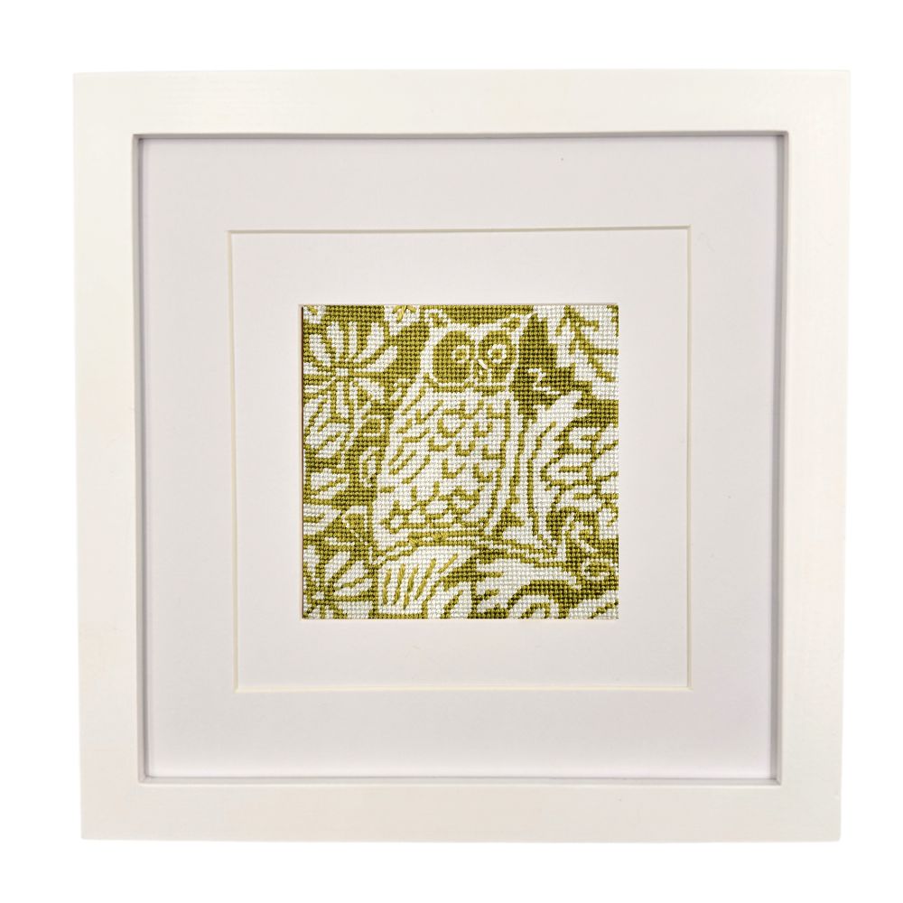 Framed needlepoint owl design on a white background