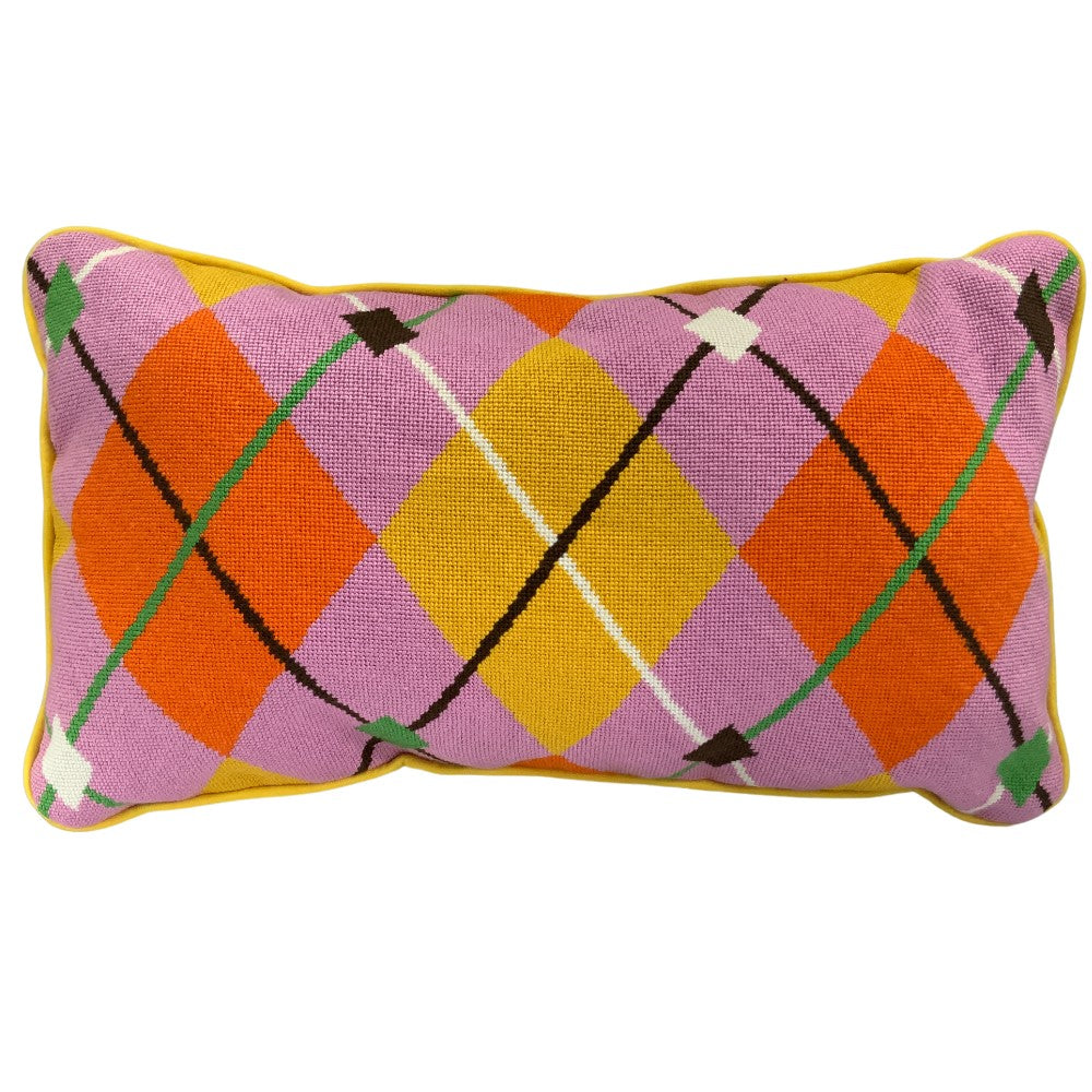 Colorful argyle patterned needlepoint pillow on a white background