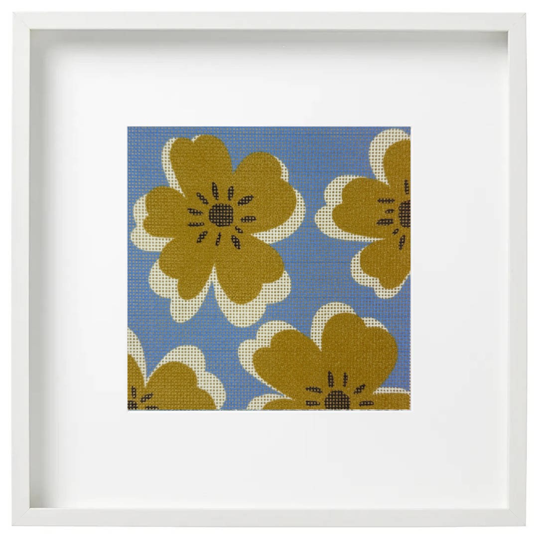 Framed needlepoint canvas of modern blooms on a blue background