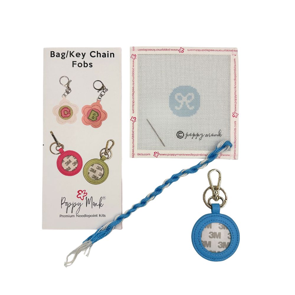 Needlepoint kit with a small round bow design and blue fob