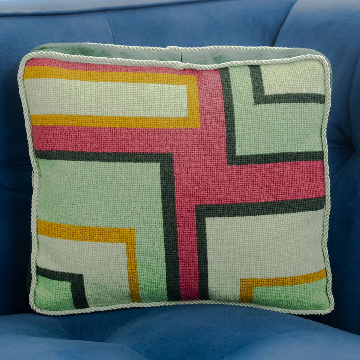 needlepoint pillow on a sofa