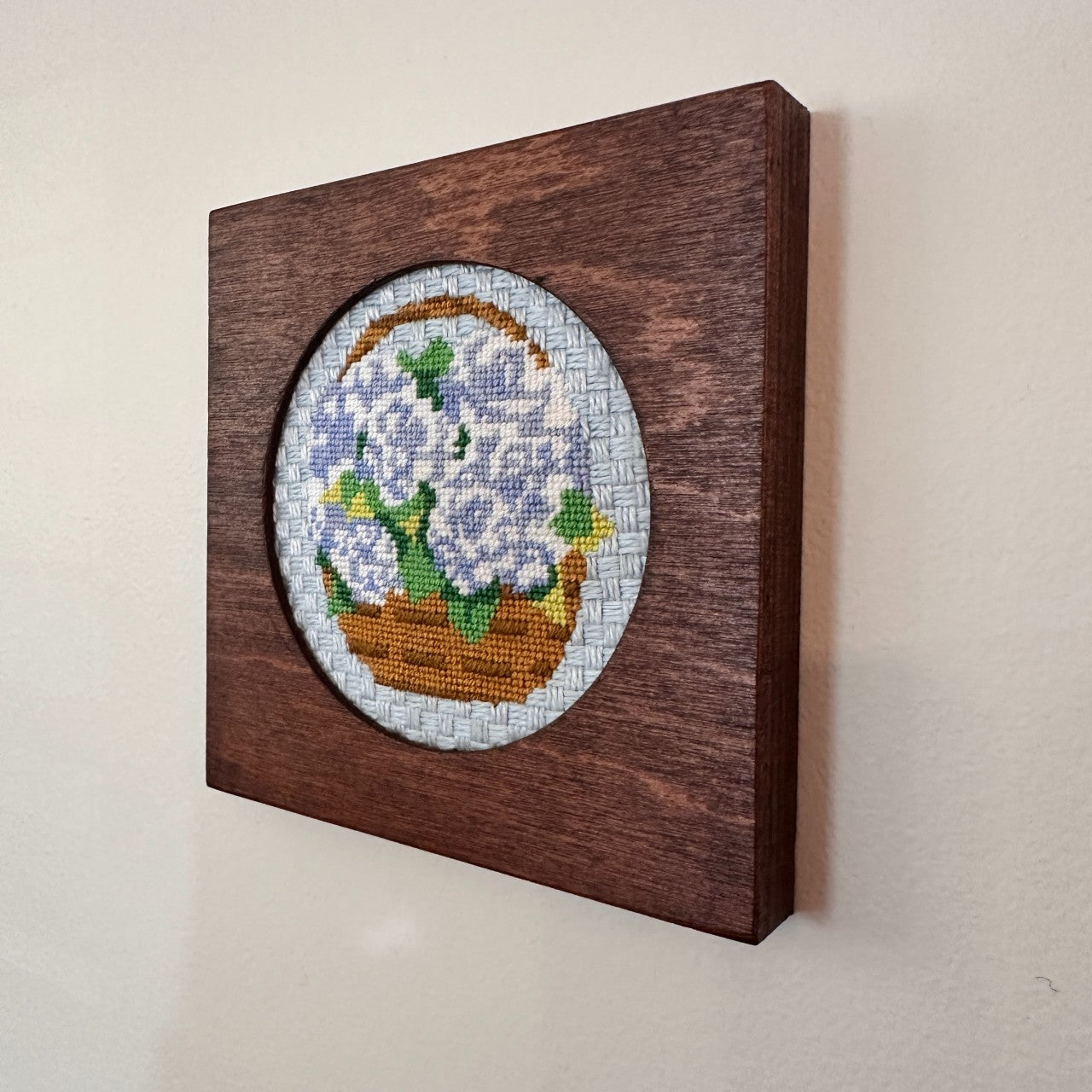 frame for needlepoint ornament on a wall