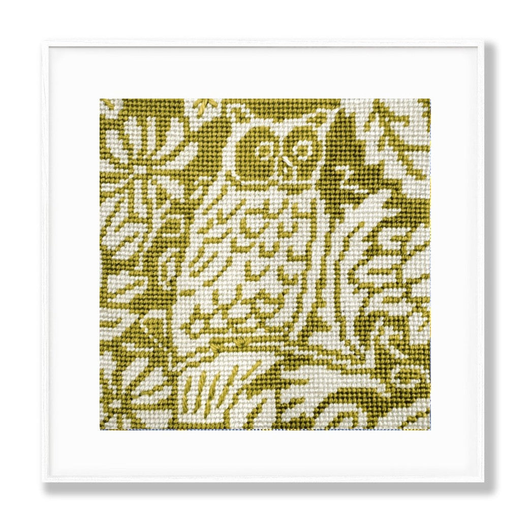 Needlepoint owl design on a green background with a white border