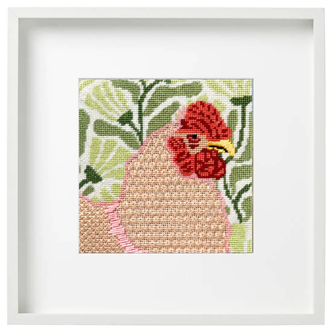 Framed needlepoint picture of a rooster with a red comb on a white background