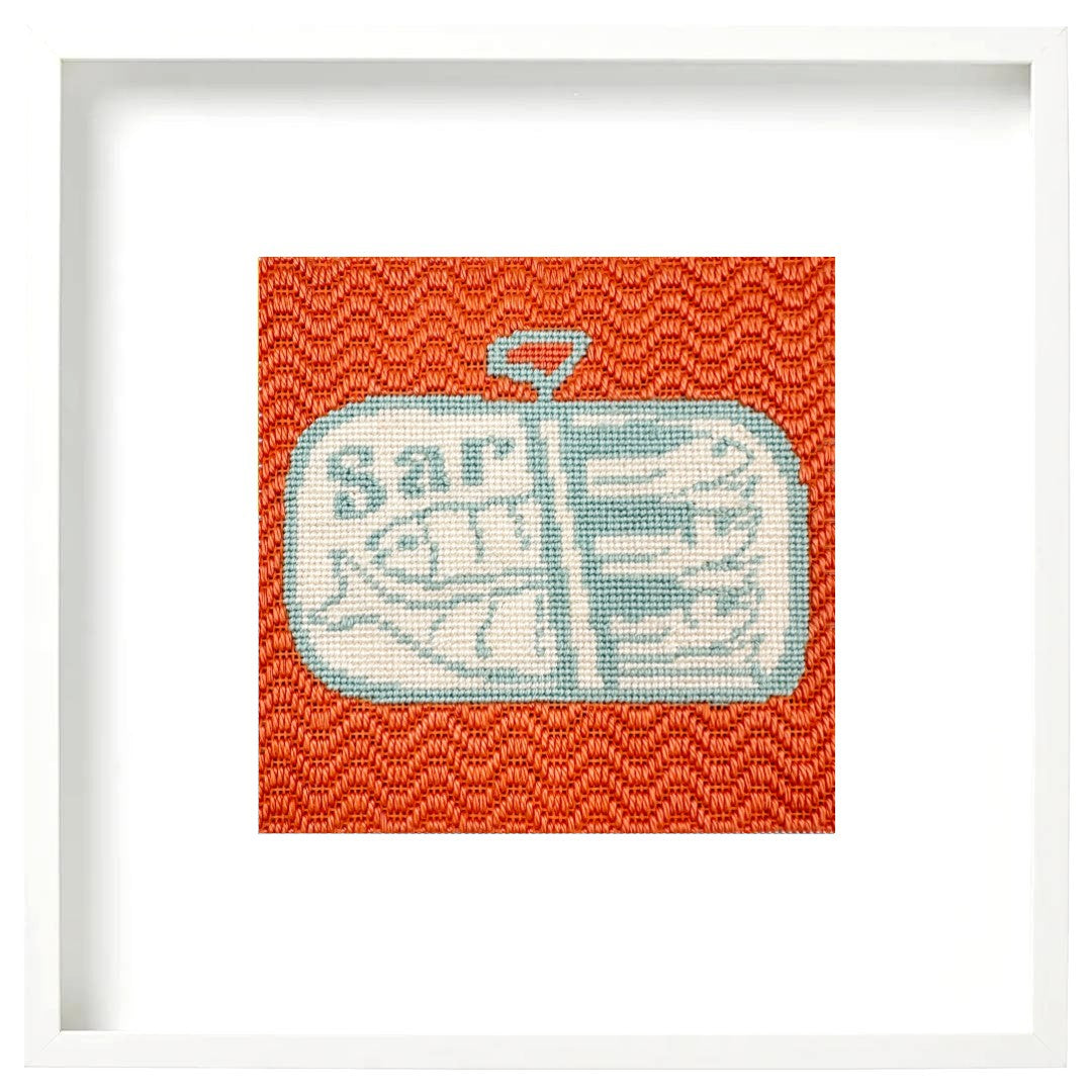 A framed needlepoint sardines design