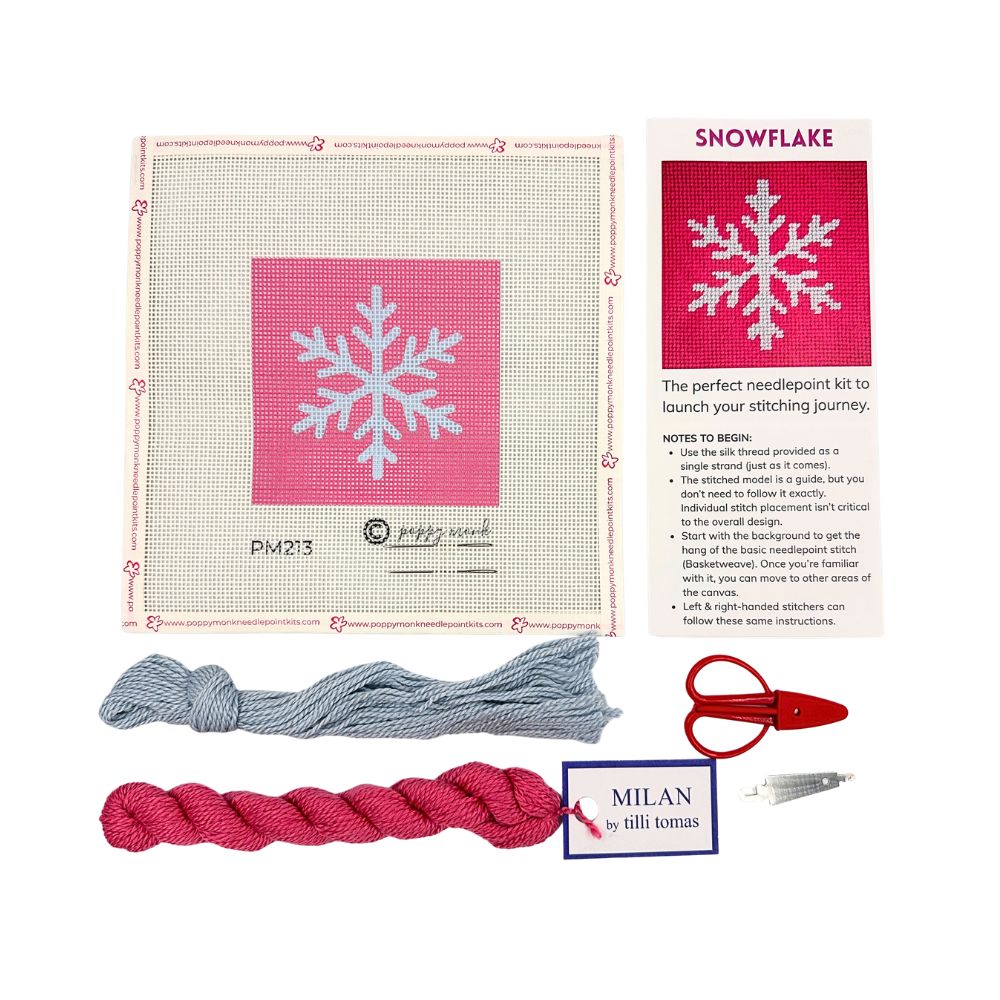 A snowflake needlepoint kit with threads and scissors