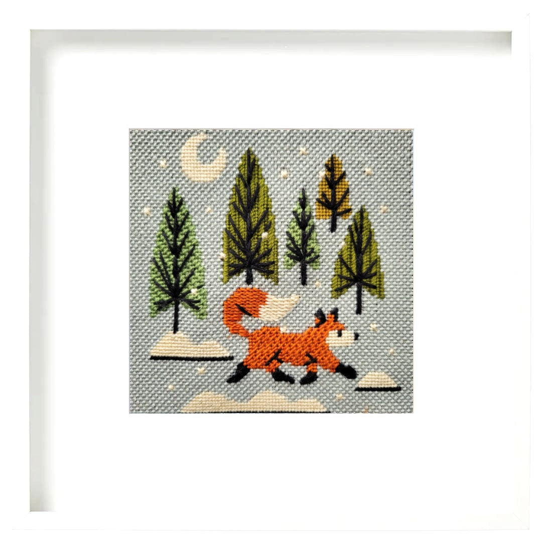 Needlepoint design of a fox in a forest with trees and rocks on a gray background.
