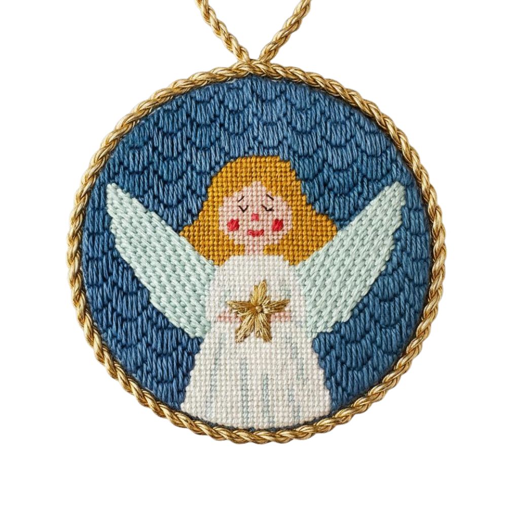 Needlepoint angel ornament with gold cord on a white background