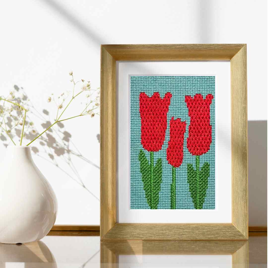 Tulips beginner needlepoint kit with four stitches.