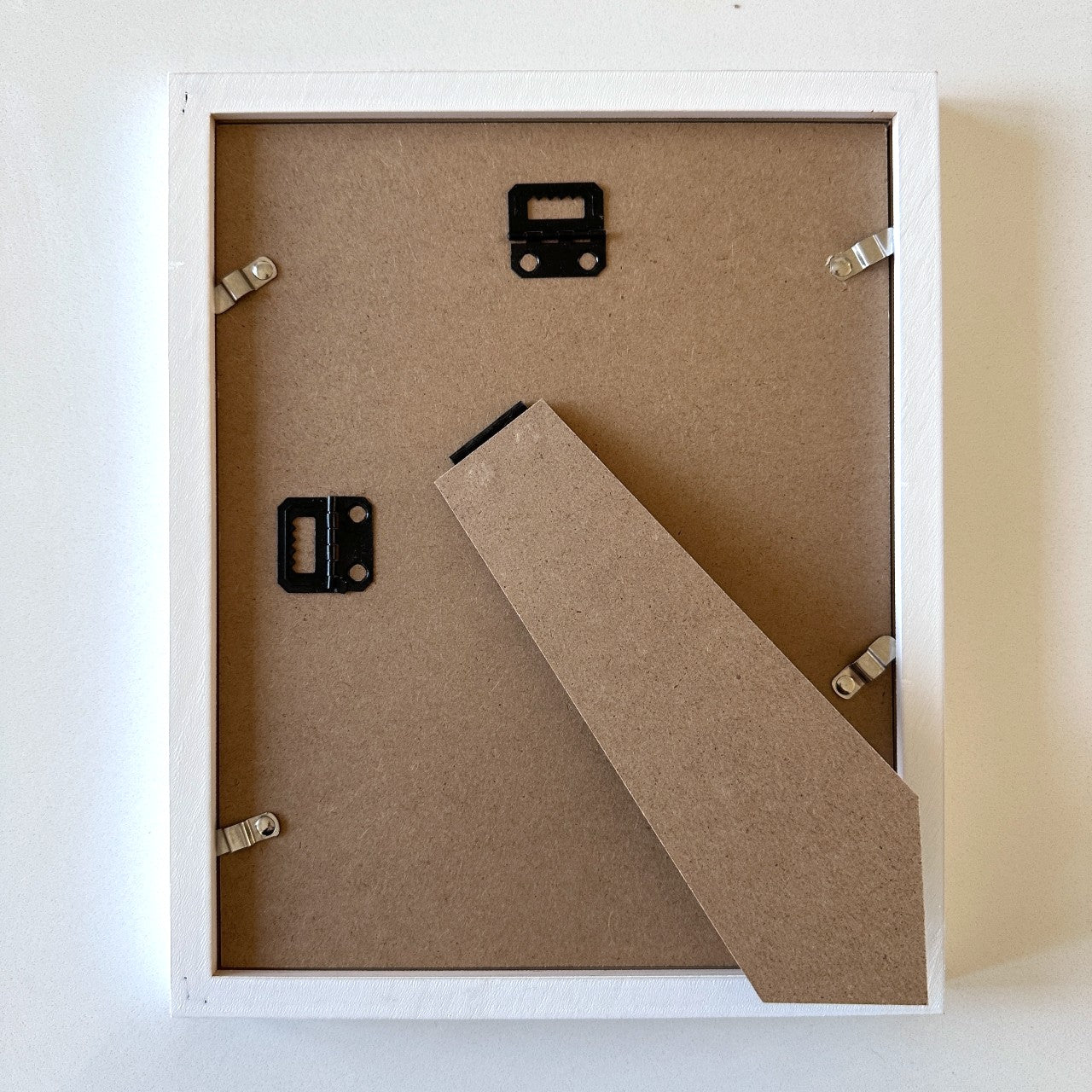 White rectangle frame with mat for 4" x 6" needlepoint canvas shown at the back.