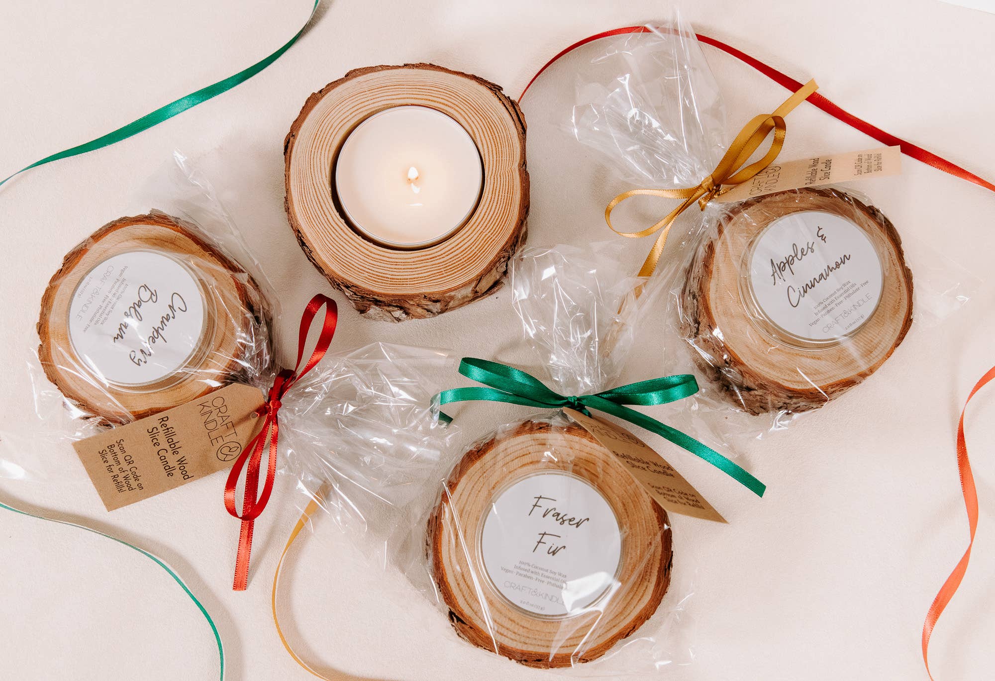 Wooden coasters with candles and ribbons on a light background