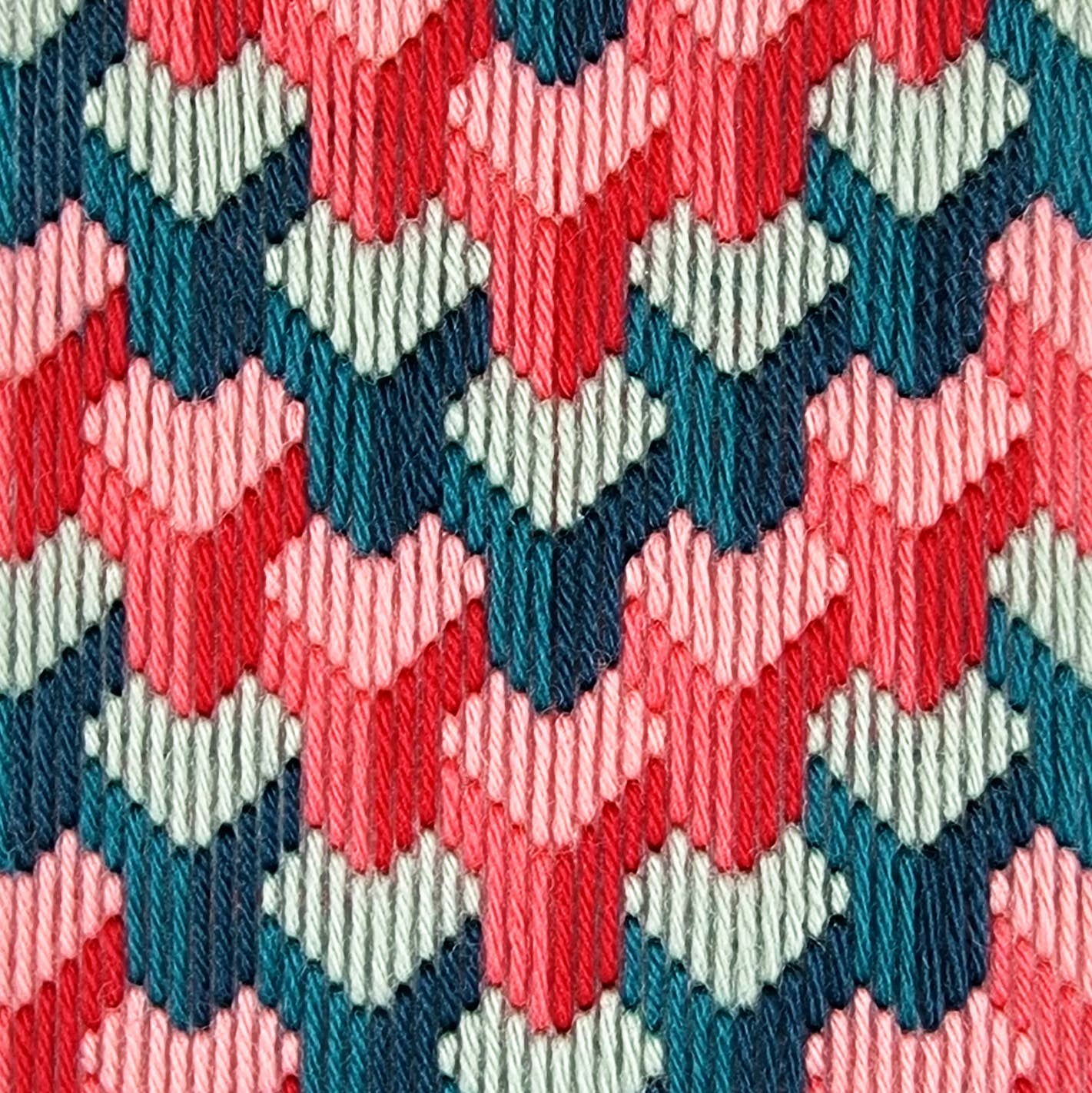 Close-up of a colorful geometric pattern with red, blue, and green hues.