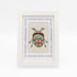 The Beetle kit stitched and in a white frame with a mat with a decorative blue watercolor bamboo border.