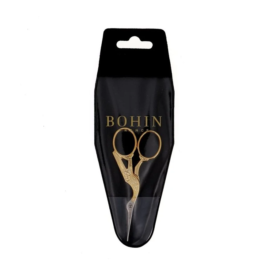 Black packaging with gold scissors design and &