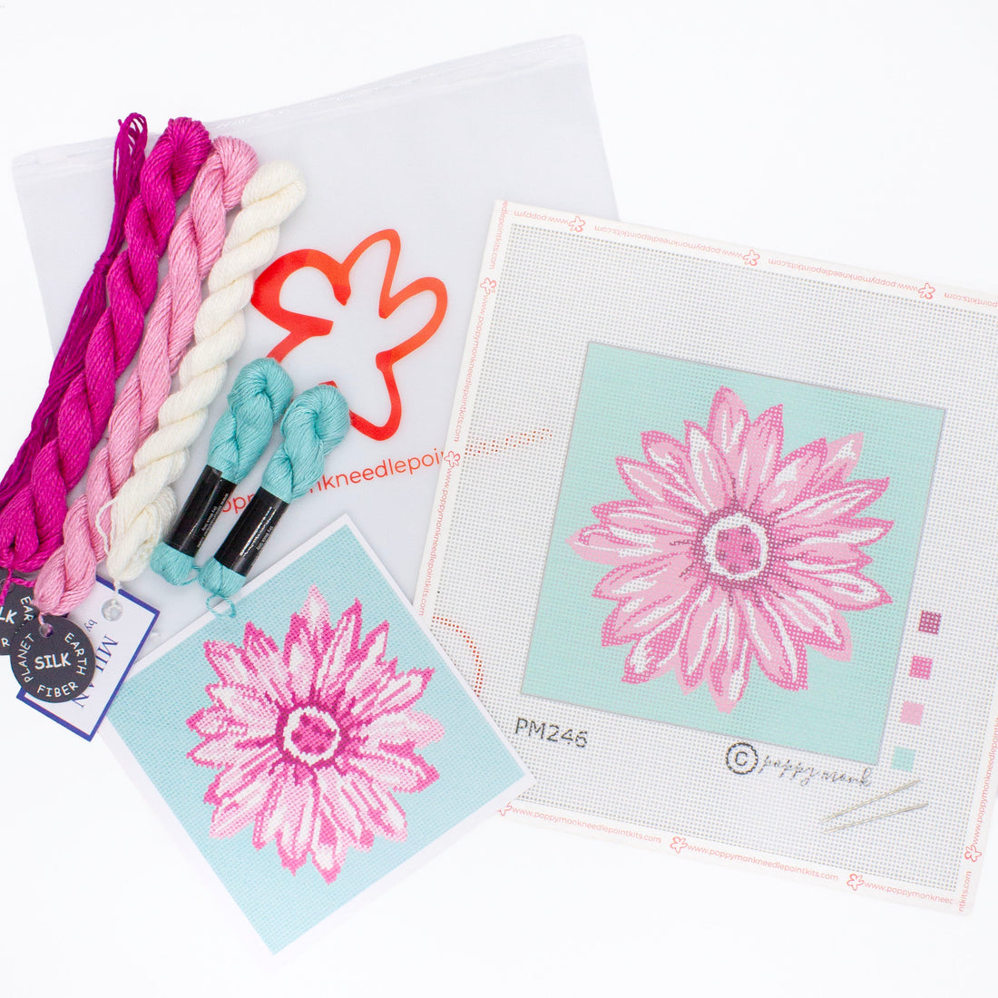 The Daisy kit components on a white background. This includes the printed canvas, colorful threads, an instruction card, needles, and a bag with the Poppy Monk logo on it.