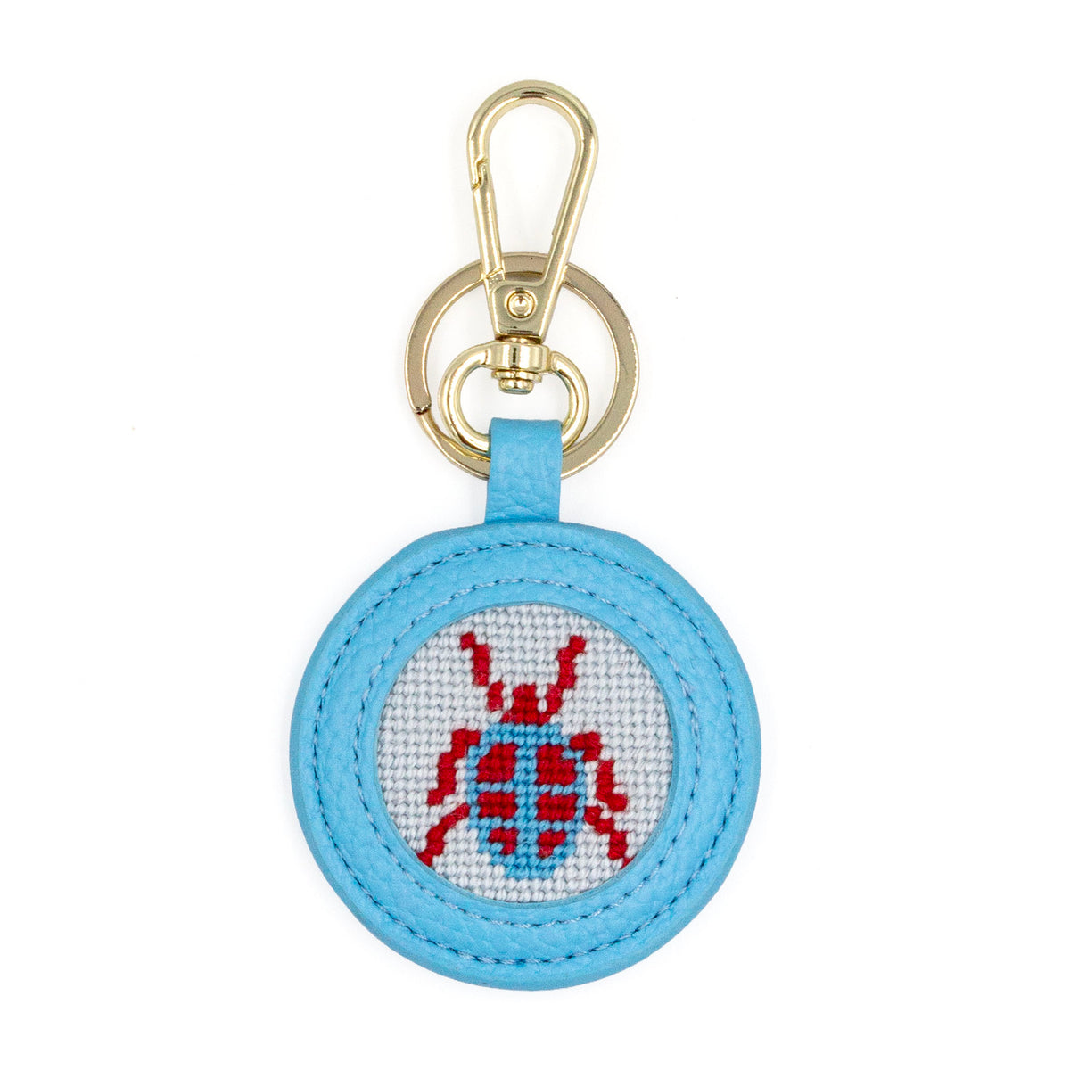 The Blue Beetle design stitched and in a blue circular fob with gold key rings.