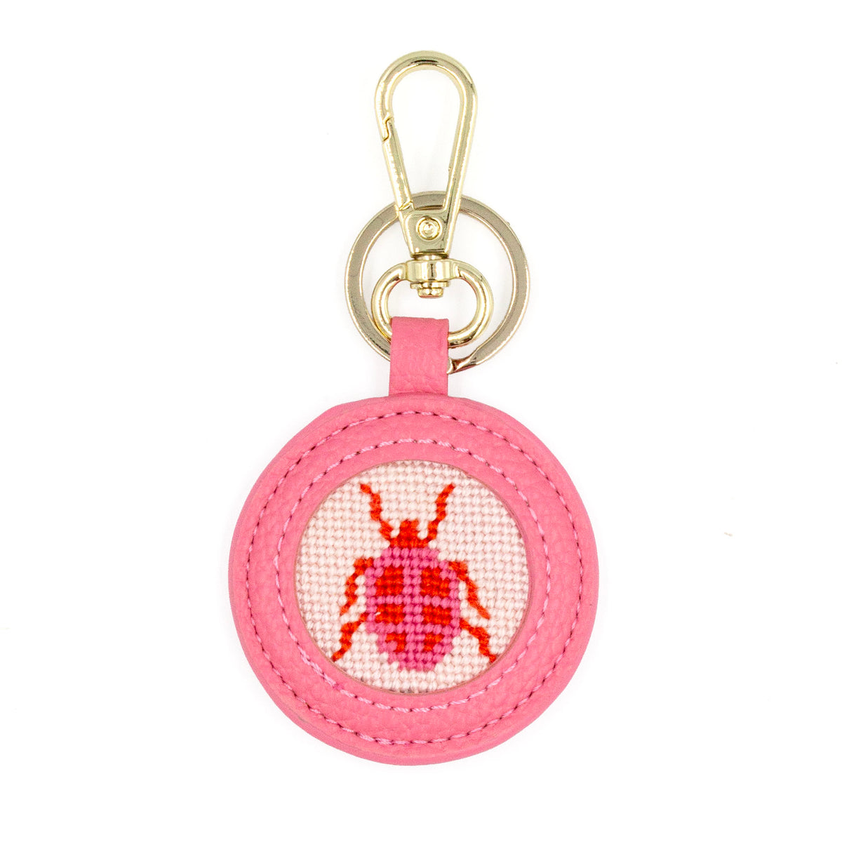 The Pink Beetle design stitched and in a pink circular fob with gold key rings.
