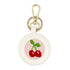The Cherries design stitched and in a white circular fob with gold key rings.