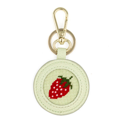 The Strawberry design stitched and in a green circular fob with gold key rings.