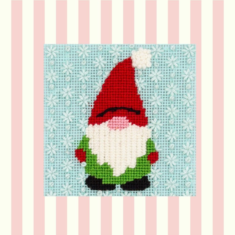 gnome needlepoint design with decorative stitches on a striped background