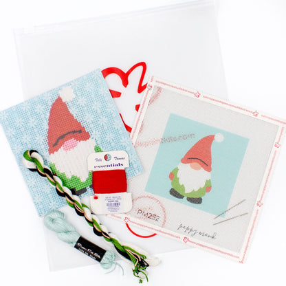 The Gnome kit components on a white background. There is a canvas with the design, an instructional brochure, colorful threads, needles, and clear bag with the Poppy Monk logo on it.