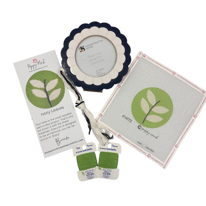 Needlepoint kit with round modern leaf design on 18 count canvas and a scalloped frame