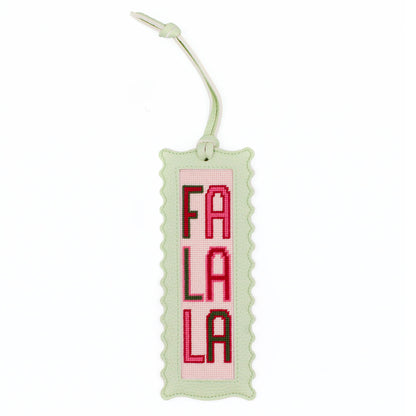 The Fa La La design stitched and finished in a pale green leather hang tag with a scalloped edge.