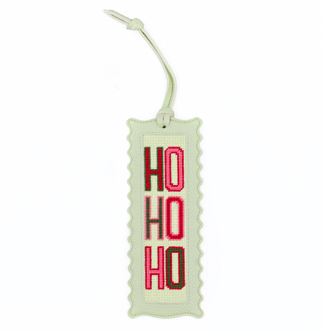 The Ho Ho Ho design stitched and finished in a pale green leather hang tag with a scalloped edge.