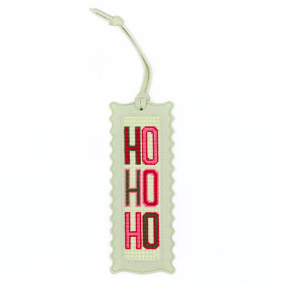 The Ho Ho Ho design stitched and finished in a pale green leather hang tag with a scalloped edge.