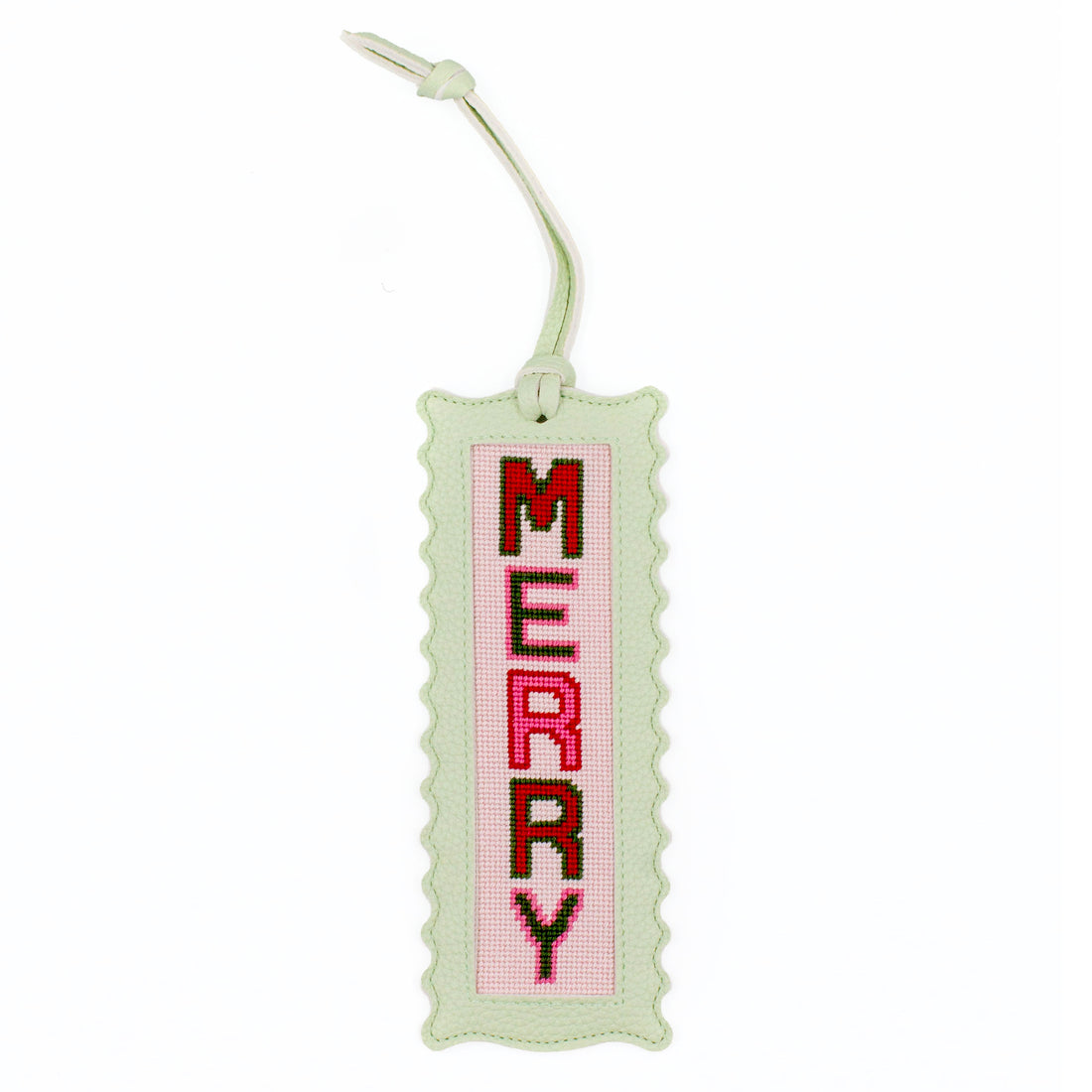 The Merry design stitched and finished in a pale green leather hang tag with a scalloped edge.
