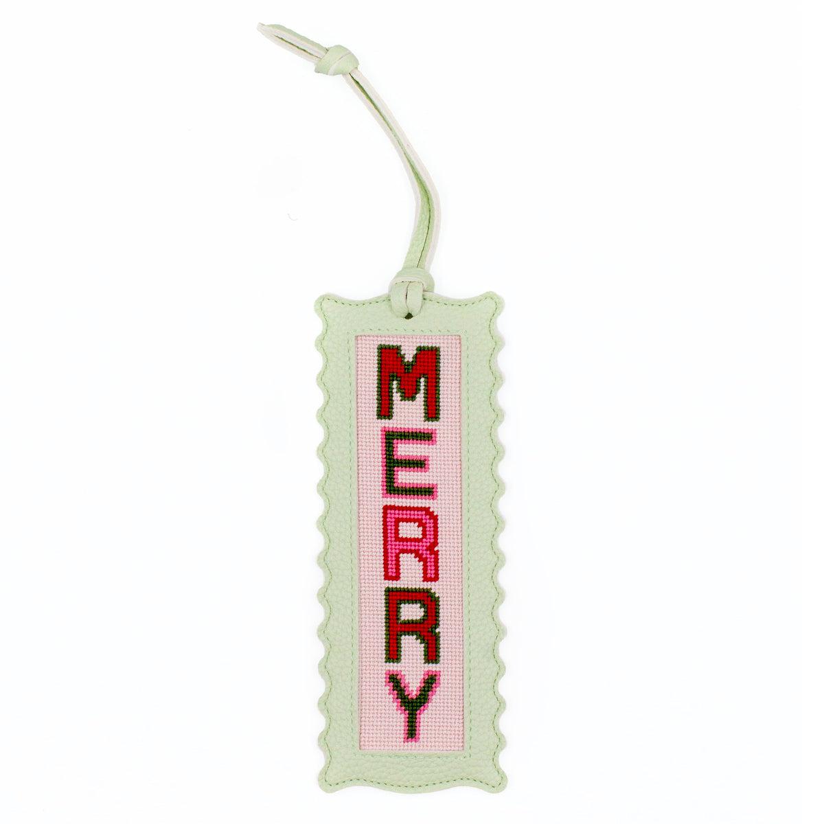 The Merry design stitched and finished in a pale green leather hang tag with a scalloped edge.