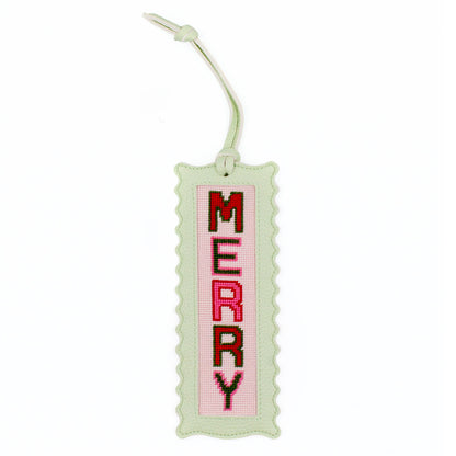 The Merry design stitched and finished in a pale green leather hang tag with a scalloped edge.