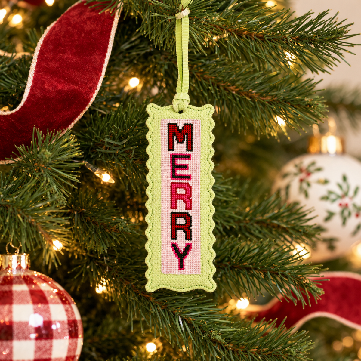 Merry ornament hanging on a Christmas tree