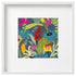 A framed square canvas print featuring a colorful floral and botanical pattern on a dark blue-gray background, set within a wide white frame.