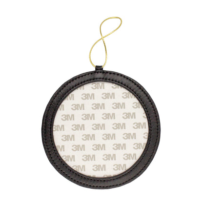 A round black leather frame-style ornament.