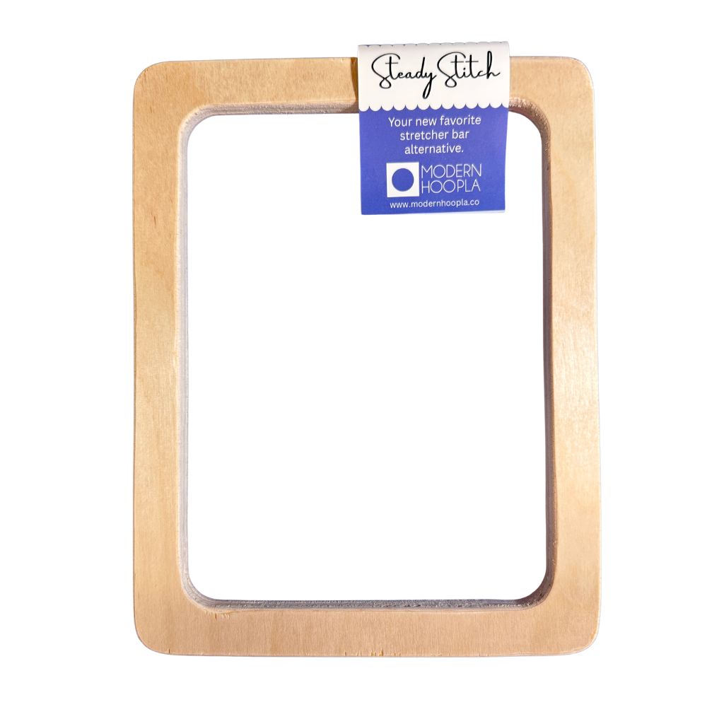 Wooden stretcher bar frame with a Modern Hoopla label on a white background