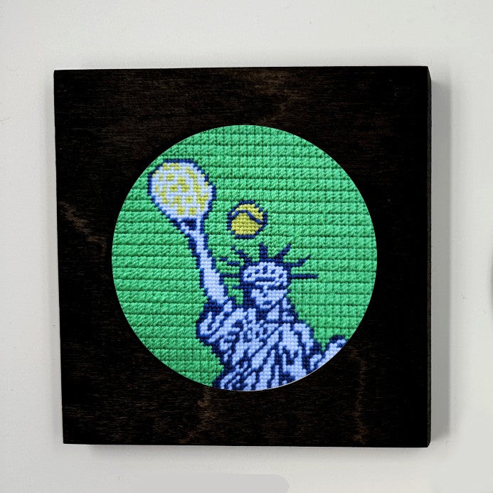 U.S. Open needlepoint in a black frame