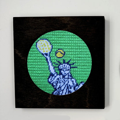 U.S. Open needlepoint in a black frame