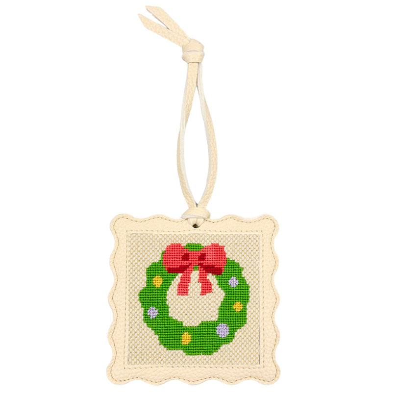 The Wreath design stitched and put inside the scallop-edged cream square hanger.