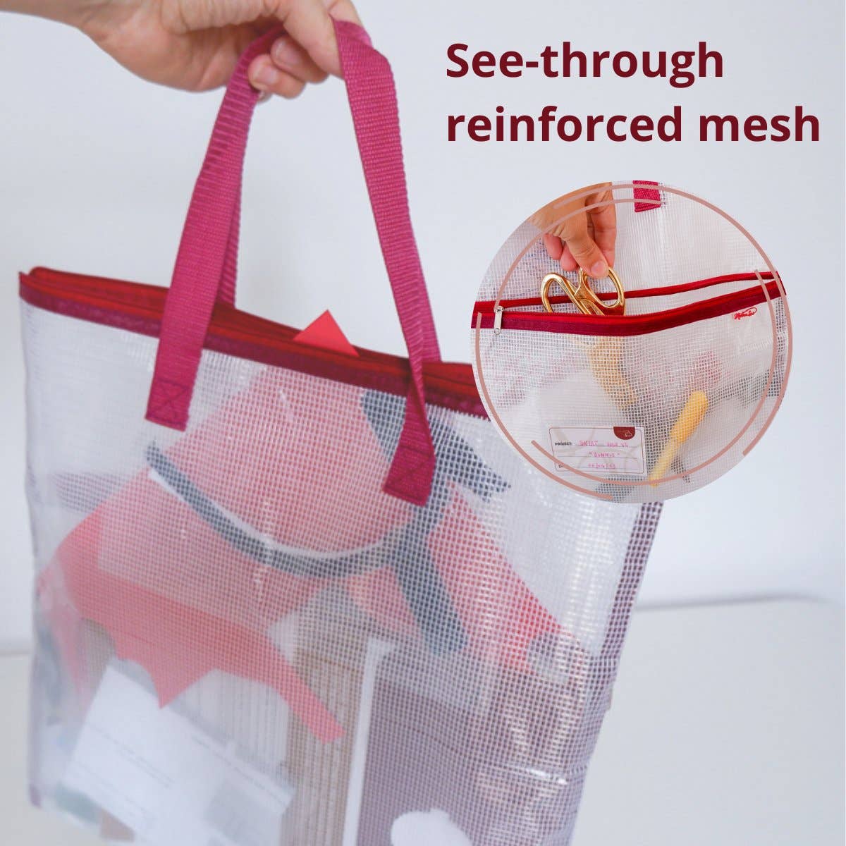 Mesh needlepoint project bag with pink handle and reinforce mesh, showing items inside.