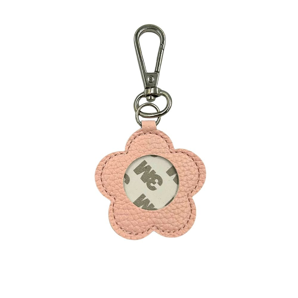 Pink flower-shaped keychain with a metal clasp on a white background