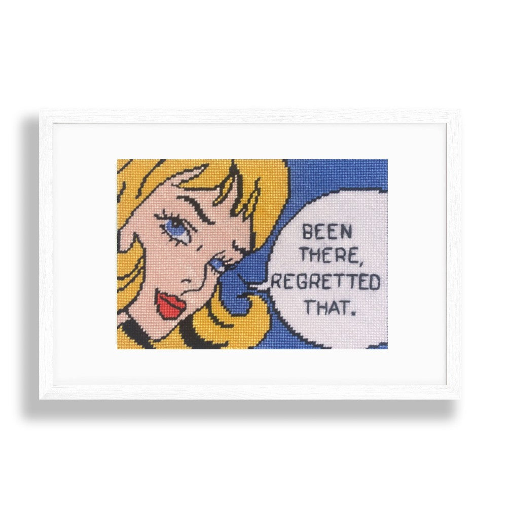 Comic-style needlepoint illustration of a character with a speech bubble saying &