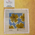 needlepoint canvas of modern flowers on a blue background